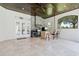 Covered outdoor kitchen with built-in grill, bar seating, and stone accents at 9905 Lanai View Ct, Windermere, FL 34786