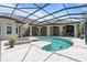 Lush pool area with a unique pool design, spa, and screened-in enclosure at 9905 Lanai View Ct, Windermere, FL 34786
