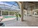 Serene screened-in pool area with an expansive patio, pool, and lush greenery at 9905 Lanai View Ct, Windermere, FL 34786