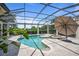 Luxury pool area with a pool, spa, elegant columns, and manicured landscaping at 9905 Lanai View Ct, Windermere, FL 34786