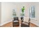 Sitting area in main bedroom with hardwood floors, plantation shutters, and views of the pool at 9905 Lanai View Ct, Windermere, FL 34786