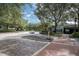 A street view with a brick road, trees, and storefronts in a charming community at 9905 Lanai View Ct, Windermere, FL 34786