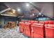 Home theater offers red seating, dim lighting, and a large viewing screen at 9905 Lanai View Ct, Windermere, FL 34786
