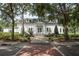 Front view of the community town hall with benches, landscaping, and red brick entry at 9905 Lanai View Ct, Windermere, FL 34786