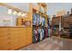 Large custom closet with shelves, drawers, hanging rods, boxes, and mirrored vanity at 9905 Lanai View Ct, Windermere, FL 34786