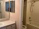 Bathroom featuring a single sink vanity, a shower/tub combo, and light colored wall tiles at 11039 Prairie Hawk Dr, Orlando, FL 32837