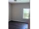 Cozy bedroom with a ceiling fan, new laminate flooring, and a sunlit window framing a peaceful outdoor view at 11039 Prairie Hawk Dr, Orlando, FL 32837