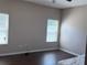 Well-lit bedroom with laminate flooring, two large windows and neutral walls at 11039 Prairie Hawk Dr, Orlando, FL 32837