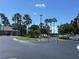 Well-maintained community entrance with lush landscaping, palm trees, and attractive architecture at 11039 Prairie Hawk Dr, Orlando, FL 32837