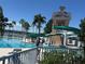 Resort-style community pool with a water slide, surrounded by palm trees, and comfortable seating at 11039 Prairie Hawk Dr, Orlando, FL 32837