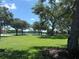 Scenic community park with a lake view framed by mature trees and manicured green space at 11039 Prairie Hawk Dr, Orlando, FL 32837