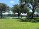 Lush community park overlooking a tranquil lake, featuring mature trees and inviting benches at 11039 Prairie Hawk Dr, Orlando, FL 32837