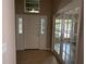 Bright foyer with tile flooring and French doors, leads to various rooms in this well-lit home at 11039 Prairie Hawk Dr, Orlando, FL 32837