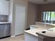 Kitchen with tile flooring, stainless steel dishwasher, and a large wrap around counter with room for barstools at 11039 Prairie Hawk Dr, Orlando, FL 32837