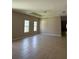 Spacious living room featuring tile floors, tray ceiling, and two large windows offering ample natural light at 11039 Prairie Hawk Dr, Orlando, FL 32837