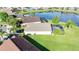 Aerial view of the property featuring a screened pool, well-maintained lawn, and serene pond at 1014 Prey Ct, Kissimmee, FL 34746