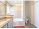 Bathroom featuring double sinks, granite counters, tile flooring, jacuzzi tub and glass shower at 1014 Prey Ct, Kissimmee, FL 34746
