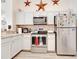 The Kitchen boasts stainless appliances, white cabinets and granite countertops at 1014 Prey Ct, Kissimmee, FL 34746