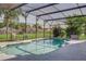 Beautiful screened-in pool with a tranquil backyard view, perfect for outdoor relaxation at 1014 Prey Ct, Kissimmee, FL 34746