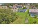 An aerial view of backyard featuring a pool, a garden, and green spaces at 107 Whitehall Way, Kissimmee, FL 34758