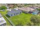 Expansive backyard featuring lush green grass, mature trees, and a screened-in pool at 107 Whitehall Way, Kissimmee, FL 34758