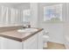 Bathroom featuring a sink, a toilet, a bathtub, and a window at 107 Whitehall Way, Kissimmee, FL 34758