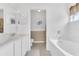 Bathroom featuring double sinks and vanity leading into a bathtub and toilet space at 107 Whitehall Way, Kissimmee, FL 34758