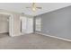 A carpeted bedroom featuring neutral walls, a window, a closet, and a bathroom at 107 Whitehall Way, Kissimmee, FL 34758