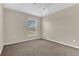 Carpeted bedroom featuring a window and neutral walls at 107 Whitehall Way, Kissimmee, FL 34758