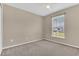 Carpeted bedroom featuring a window and neutral walls at 107 Whitehall Way, Kissimmee, FL 34758