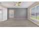 A carpeted bedroom featuring neutral walls and two windows at 107 Whitehall Way, Kissimmee, FL 34758