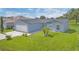 Well-maintained single-story home with a green lawn and fresh landscaping at 107 Whitehall Way, Kissimmee, FL 34758