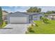 Charming single-story home featuring a two-car garage and well-manicured front yard at 107 Whitehall Way, Kissimmee, FL 34758