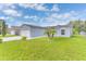 Well-maintained front yard with green grass, decorative rocks, and a lovely blue-painted home at 107 Whitehall Way, Kissimmee, FL 34758