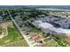 Scenic aerial shot of a residential street with houses, commercial buildings, and a view of a lake at 1197 E Grove Ave, Lake Wales, FL 33853