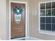 Close-up of the front door with decorative wreath and sidelight window at 1197 E Grove Ave, Lake Wales, FL 33853