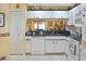 Bright kitchen with white cabinets, dark countertops, and modern appliances at 1197 E Grove Ave, Lake Wales, FL 33853