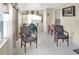 Sunroom featuring tiled floor, two upholstered chairs, and a table and chairs in background at 1197 E Grove Ave, Lake Wales, FL 33853