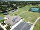 Aerial view of the community park featuring a playground, sports fields, and recreational facilities at 12021 Villanova Dr # 111, Orlando, FL 32837
