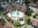 Aerial view of community pool, sun deck, and luxurious landscaping at 12021 Villanova Dr # 111, Orlando, FL 32837