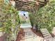 Secluded backyard garden with jacuzzi seen through an enchanting floral pergola at 12021 Villanova Dr # 111, Orlando, FL 32837