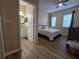 Comfortable bedroom with a ceiling fan and view into the bright bathroom with a granite topped vanity at 12021 Villanova Dr # 111, Orlando, FL 32837