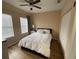 Cozy bedroom features wood floors, ceiling fan, and a full-size bed with closet at 12021 Villanova Dr # 111, Orlando, FL 32837
