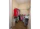 Walk-in closet with ample storage space with wire shelving and wood floor at 12021 Villanova Dr # 111, Orlando, FL 32837