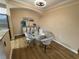 Dining area featuring a glass table with padded chairs and modern lighting at 12021 Villanova Dr # 111, Orlando, FL 32837