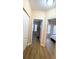 Hallway showcases beautiful wood floors and doorways to the bedrooms at 12021 Villanova Dr # 111, Orlando, FL 32837