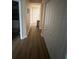 Hallway with hardwood flooring, storage closet, and neutral wall color at 12021 Villanova Dr # 111, Orlando, FL 32837