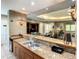 A stunning kitchenette with modern design and stainless-steel sink, perfect for light entertaining at 12021 Villanova Dr # 111, Orlando, FL 32837