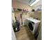 Laundry room with washer and dryer and upper shelf at 12021 Villanova Dr # 111, Orlando, FL 32837