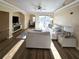 Bright living room features an electric fireplace, an office area, a sliding door to the balcony, and fan at 12021 Villanova Dr # 111, Orlando, FL 32837
